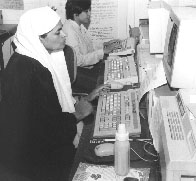 Photo of Azra, typing her stories into a computer