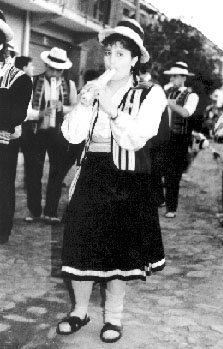 Photo of young girl playing a flute in a parade